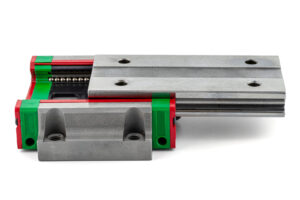 Macro photo of a old linear bearing with a linear trolley, isolated on a white background.