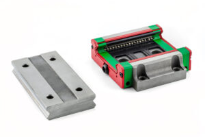 Macro photo of a old linear bearing with a linear trolley, isolated on a white background.